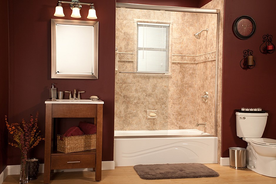 Bathroom interior with dark red walls, light wood-look flooring, vanity with a mirror, and shower/bathtub with sliding glass doors.