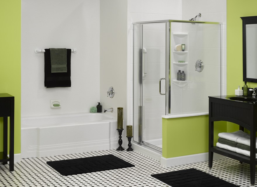 A modern bathroom with a glass shower, white bathtub, lime green walls, white tiles, black and white checkered floor, black bath mats, black towels, and black bathroom fixtures.