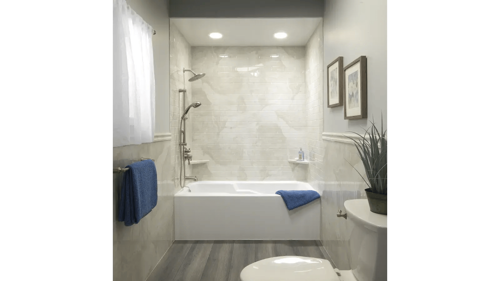 Bathroom featuring a white bathtub with marble-look tile surround, gray flooring, and neutral walls.