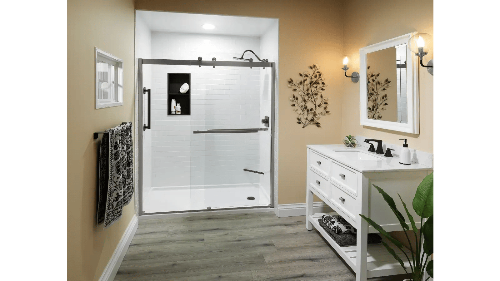 Bathroom with wood-look flooring, a white shower with sliding glass door, and a white double vanity with a white framed mirror.